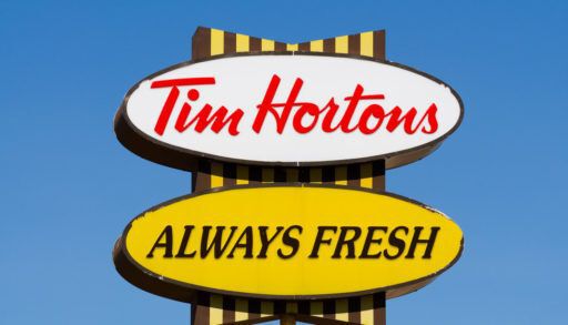 Close-up of a white and yellow Tim Hortons sign.