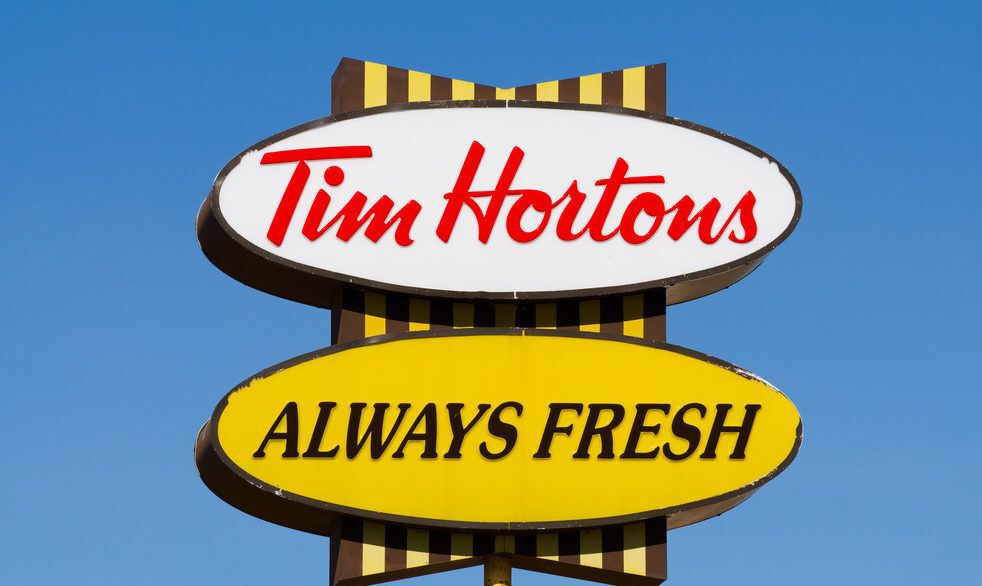 Close-up of a white and yellow Tim Hortons sign.
