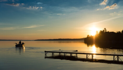 A fishing boat on Balsam Lake at sunset, Kawartha, Ontario.