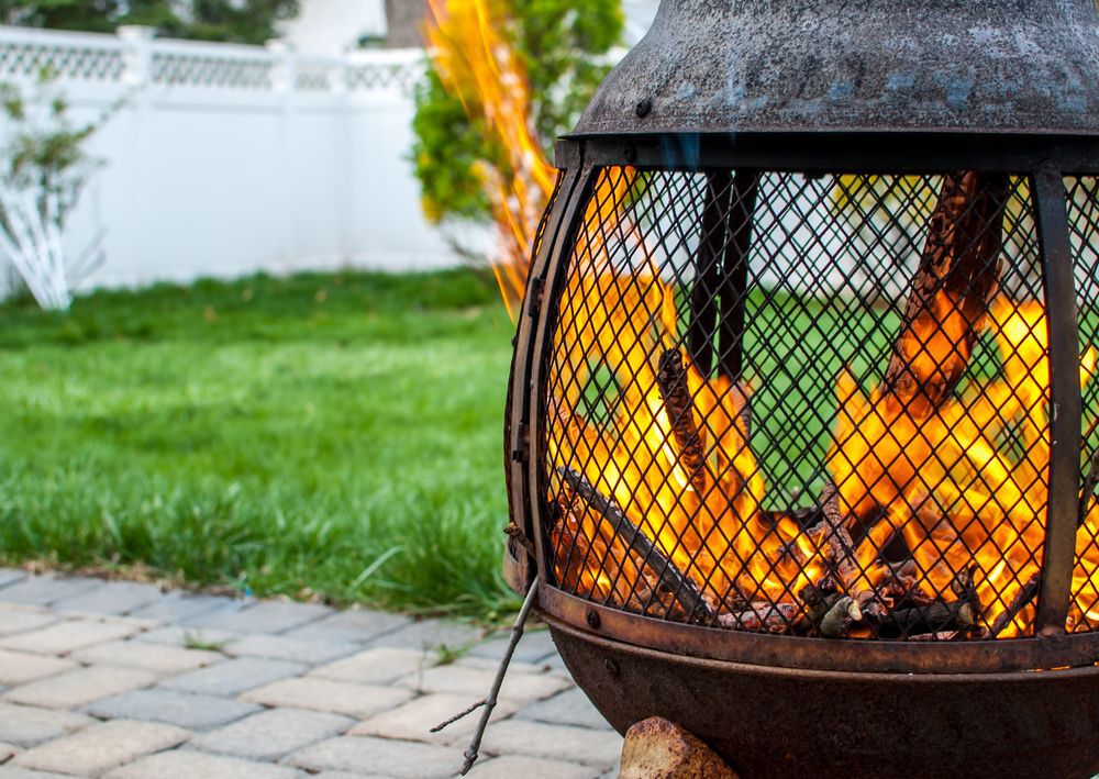 Close-up of a fire pit in a backyard.