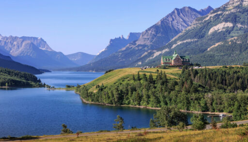 The Prince of Wales Hotel surrounded by mountains in Waterton Lakes National Park, Alberta.