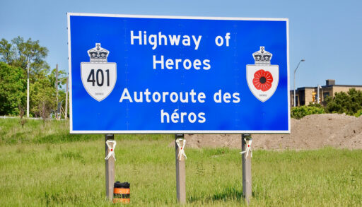 A blue Highway of Heroes sign along Highway 401 in Ontario.