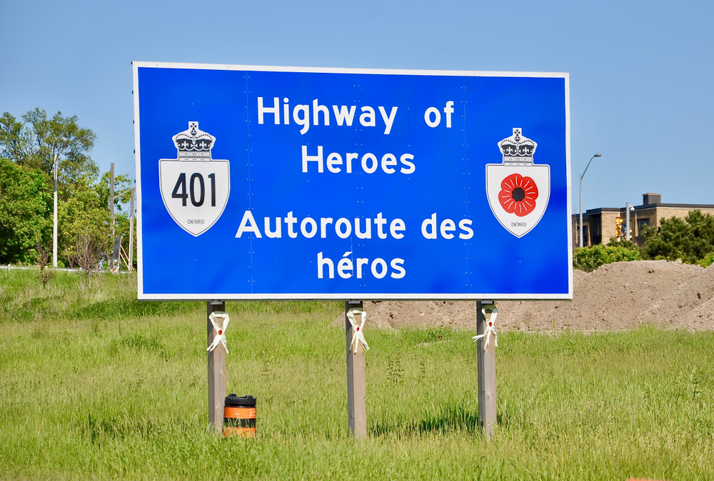 A blue Highway of Heroes sign along Highway 401 in Ontario.