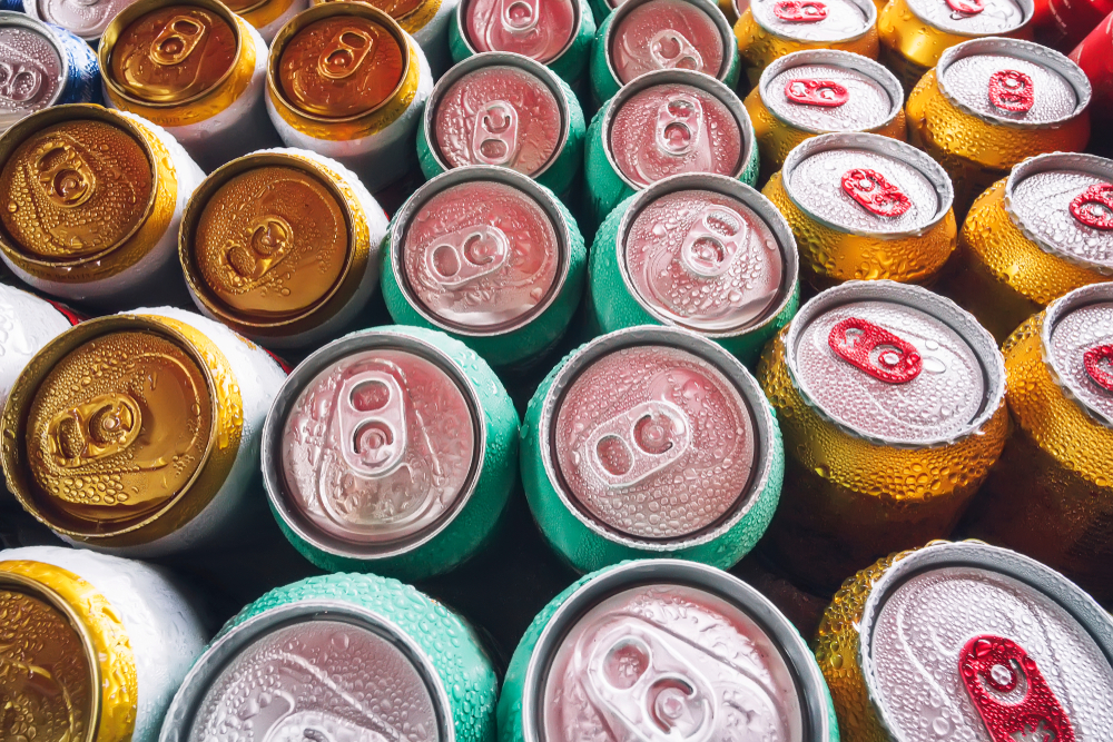 The tops of colourful beer cans lined up in rows.