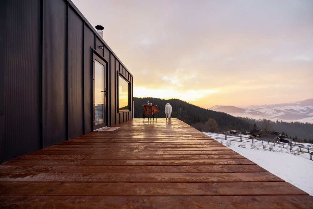 View of a tiny home terrace overlooking a snow-covered landscape.