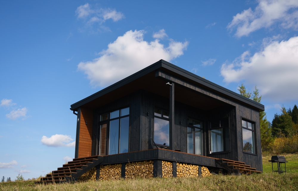Exterior of a black, modern tiny home.