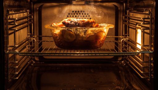 A chicken roasting in an oven.
