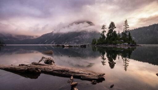 Widgeon Lake at sunrise surrounded by mountains and trees in British Columbia.