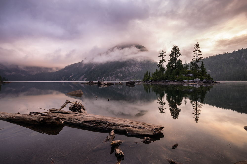 Widgeon Lake at sunrise surrounded by mountains and trees in British Columbia.