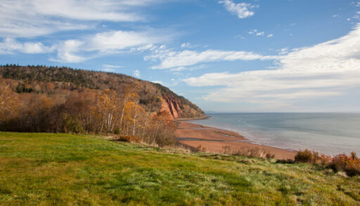 The hills of Cape Split Provincial Park in Nova Scotia next to the ocean.