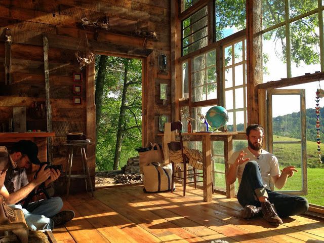 Two men sitting in front of bright wall made of windows