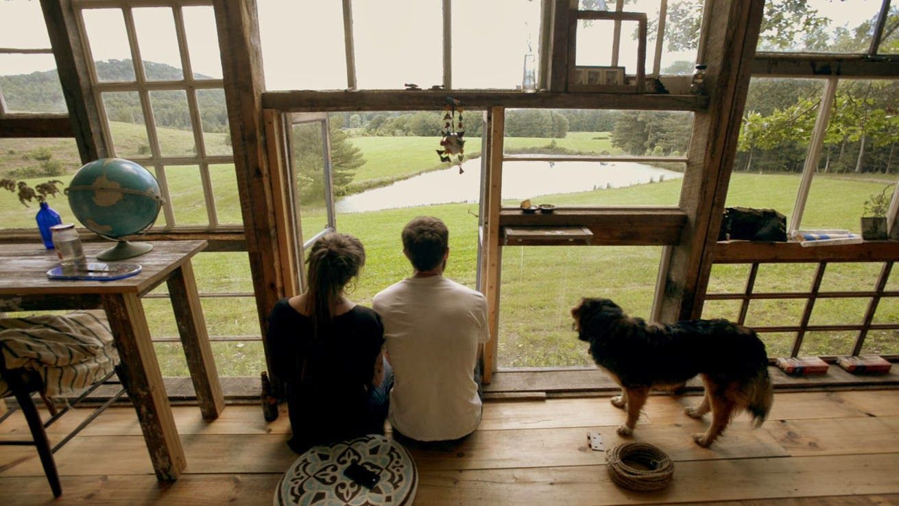 Man and woman sit at their front door