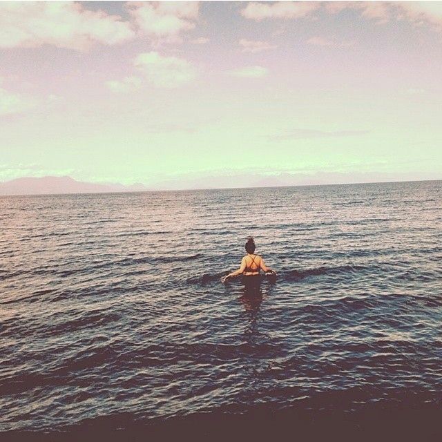 person wading in the ocean