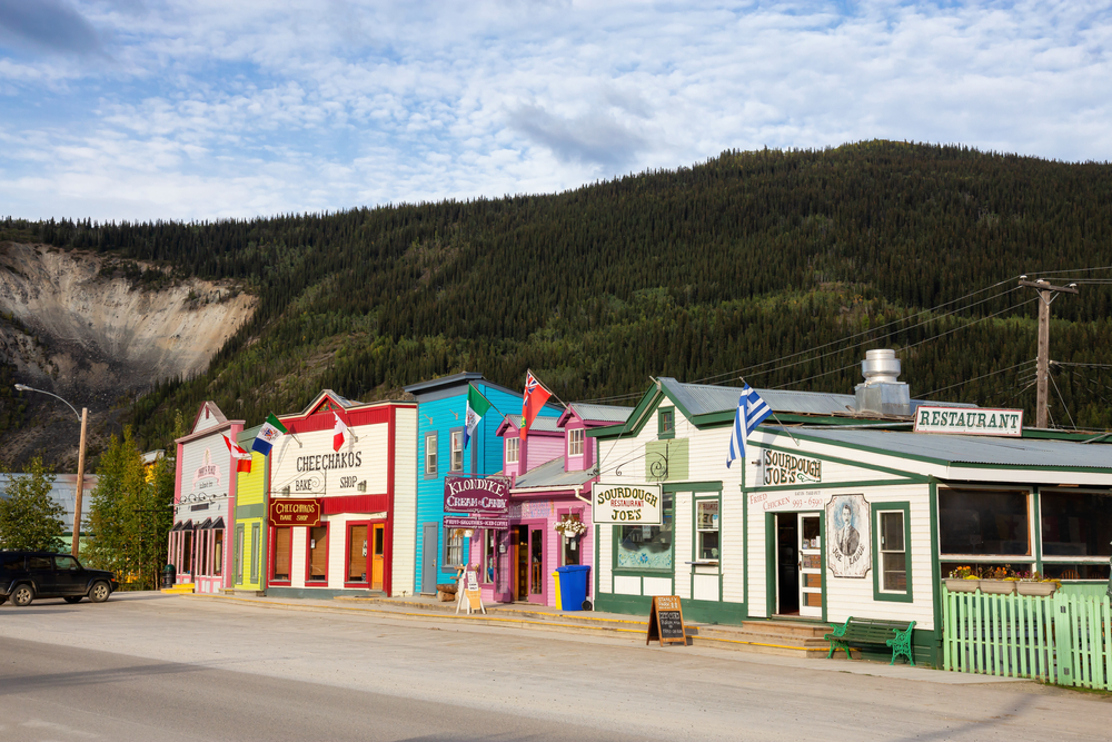 Dawson City, Yukon. Small town with colorful shop exteriors in a forest landscape.