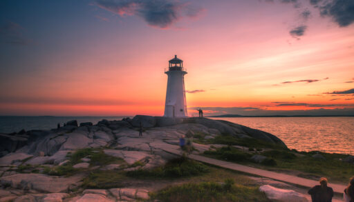 Lighthouse on rock formation at sunset. Peggy's Cove, Nova Scotia.