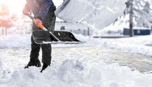 Person shovelling snow in the winter season.