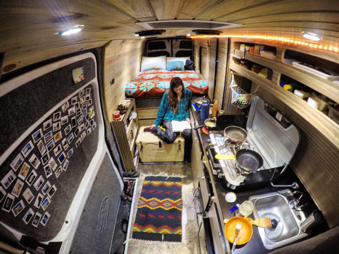 Interior of van with stove, bed, and sink