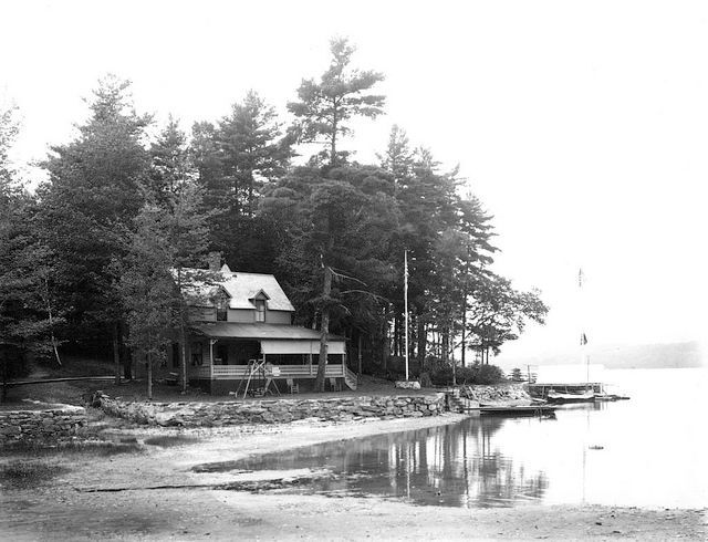 A cottage on a lake, black and white