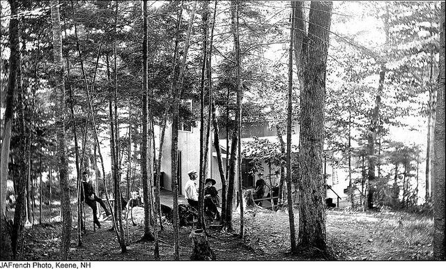 Cottage with people outdoors, black and white