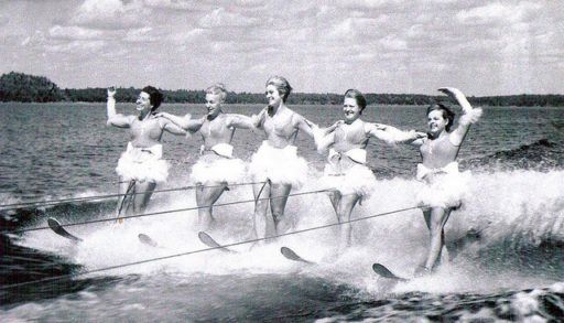 Five women waterskiing, black and white