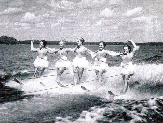 Five women waterskiing, black and white