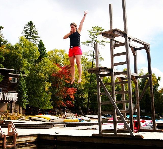 Woman jumping off diving platform