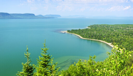 View of Lake Superior from above lined with a forest landscape.