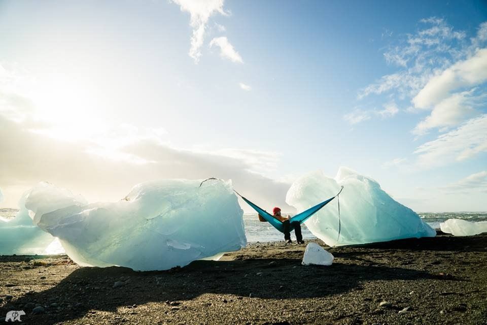 Person on a hammock tied between two ice chunks
