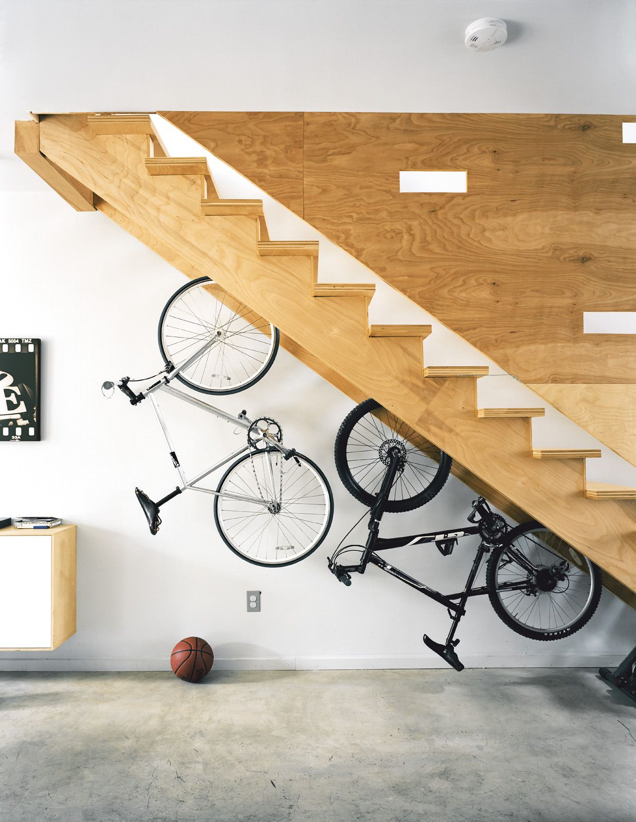 Bikes hanging under stairs