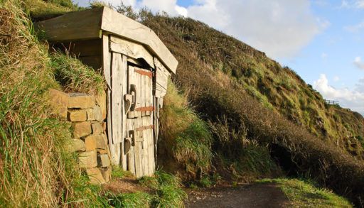 Exterior of shack built into hillside