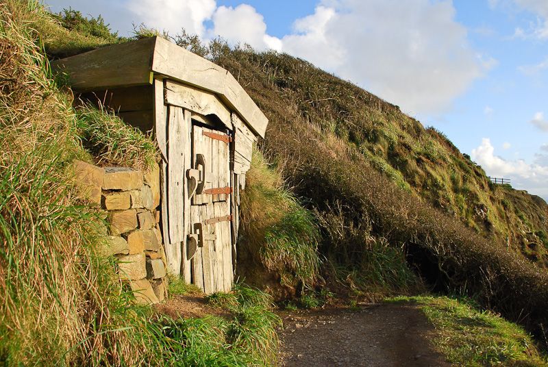 Exterior of shack built into hillside
