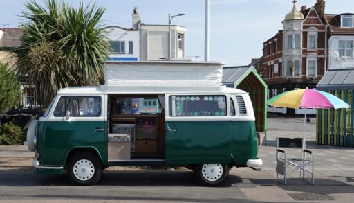 Green VW van parked on the side of a road.