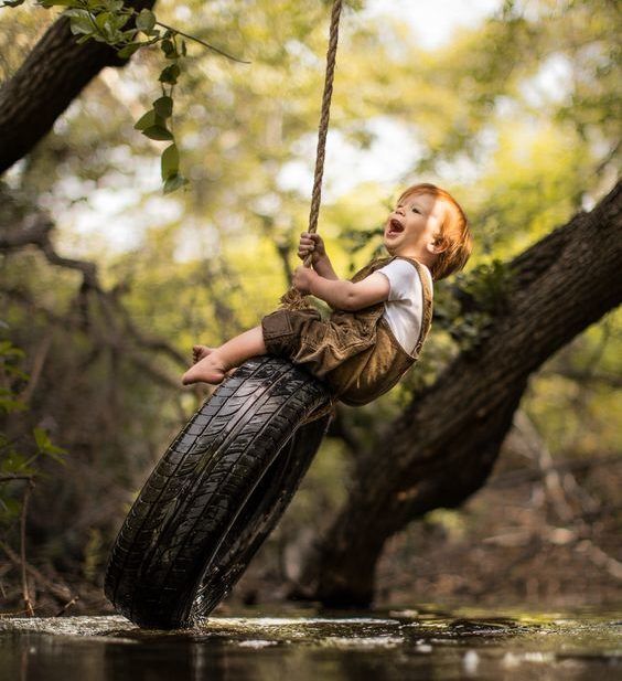 Young child on tire rope swing