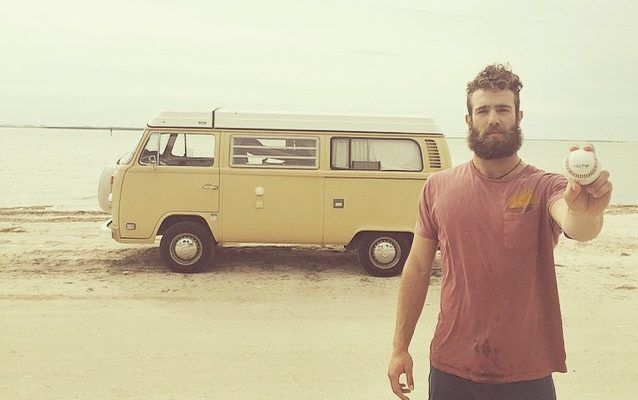 Norris in front of his van with a baseball