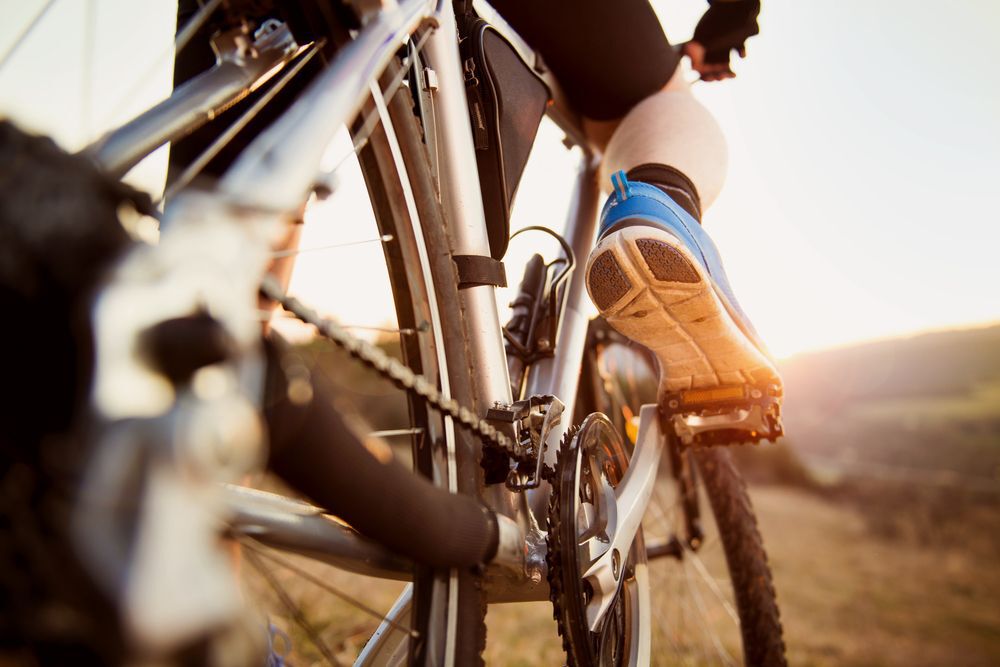 Person riding a bike in a rural area.