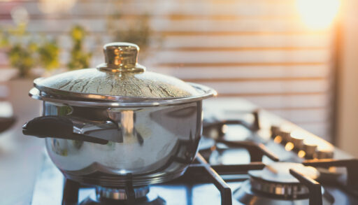 Water boiling in a pot on a stovetop.