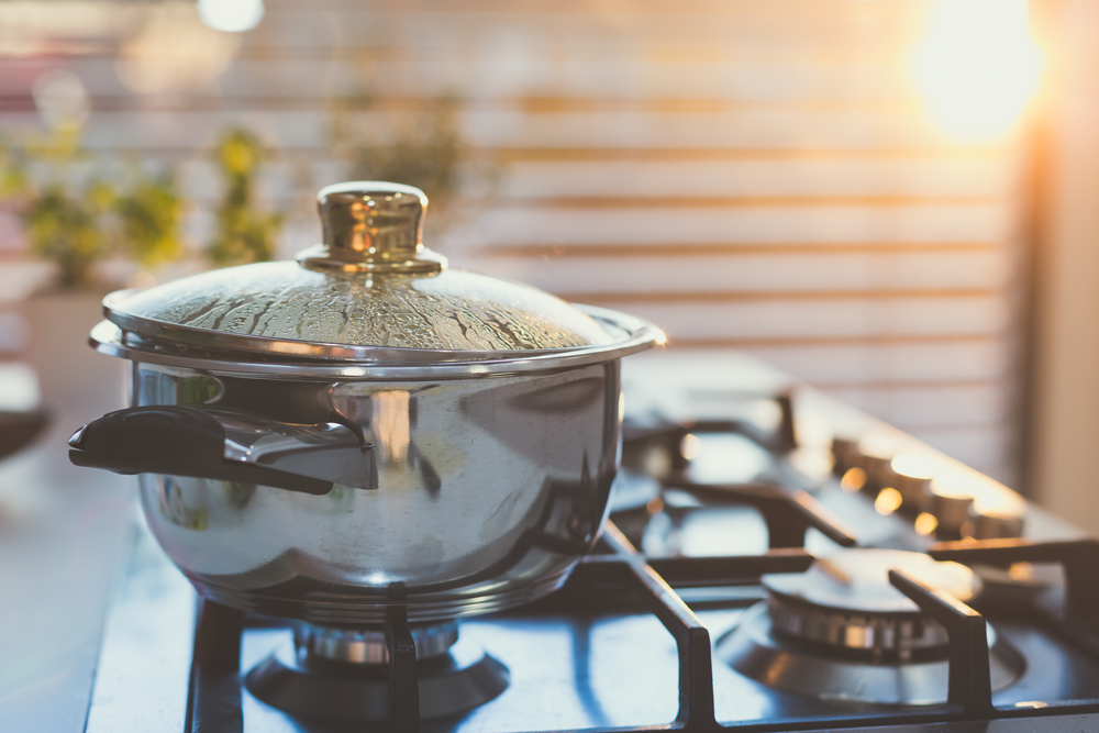Water boiling in a pot on a stovetop.