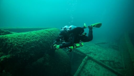 Diver exploring a shipwreck.