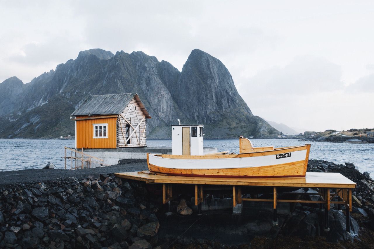 fishing cabin and boat near the water
