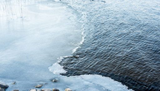Partly frozen lake in the winter time.
