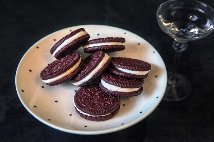 Homemade oreos next to glass of liqueur