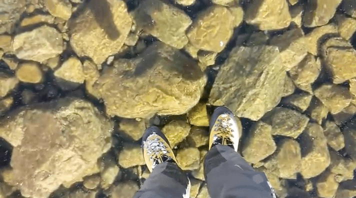 Person standing on perfectly clear ice