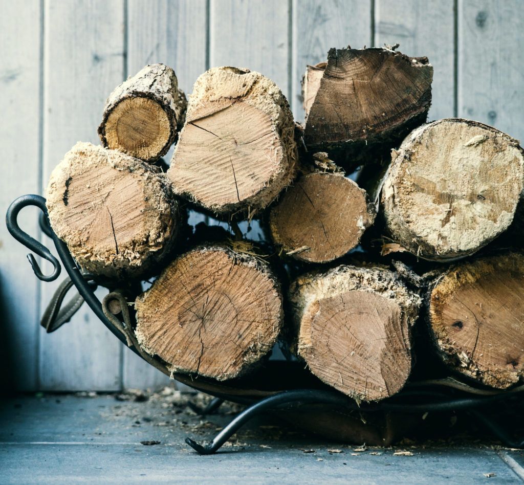 Pile of firewood stacked up indoors.