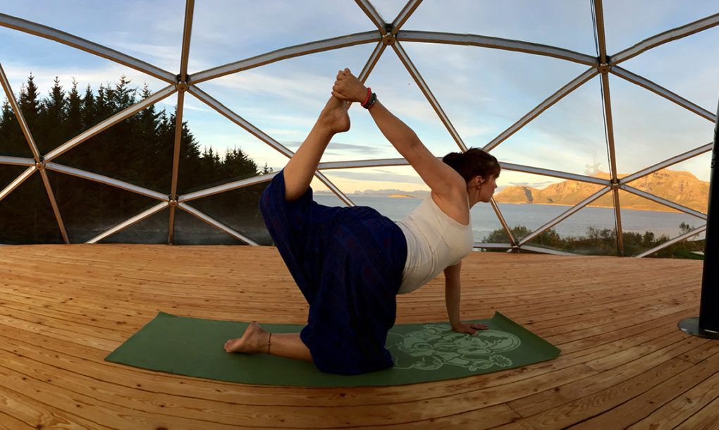 Ingrid Hjertefølger doing yoga on the home's roof