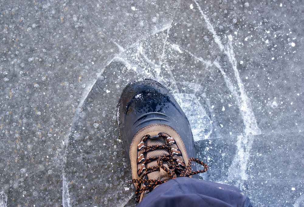 Person walking on thin ice that is beginning to break.