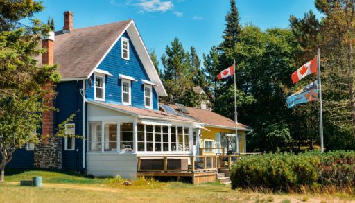 Blue cottage on a beach in Silver Islet, Ontario, Canada.