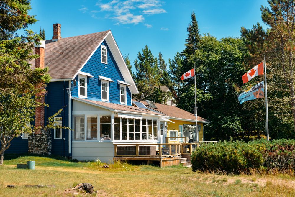 Blue cottage on a beach in Silver Islet, Ontario, Canada.