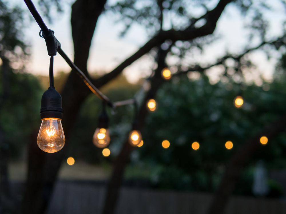 Decorative outdoor lights lit up at dusk.