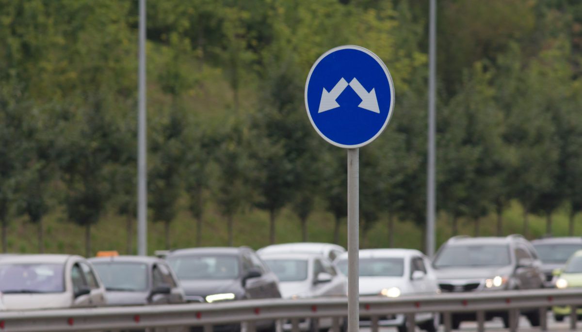 Cars sitting in traffic on a highway