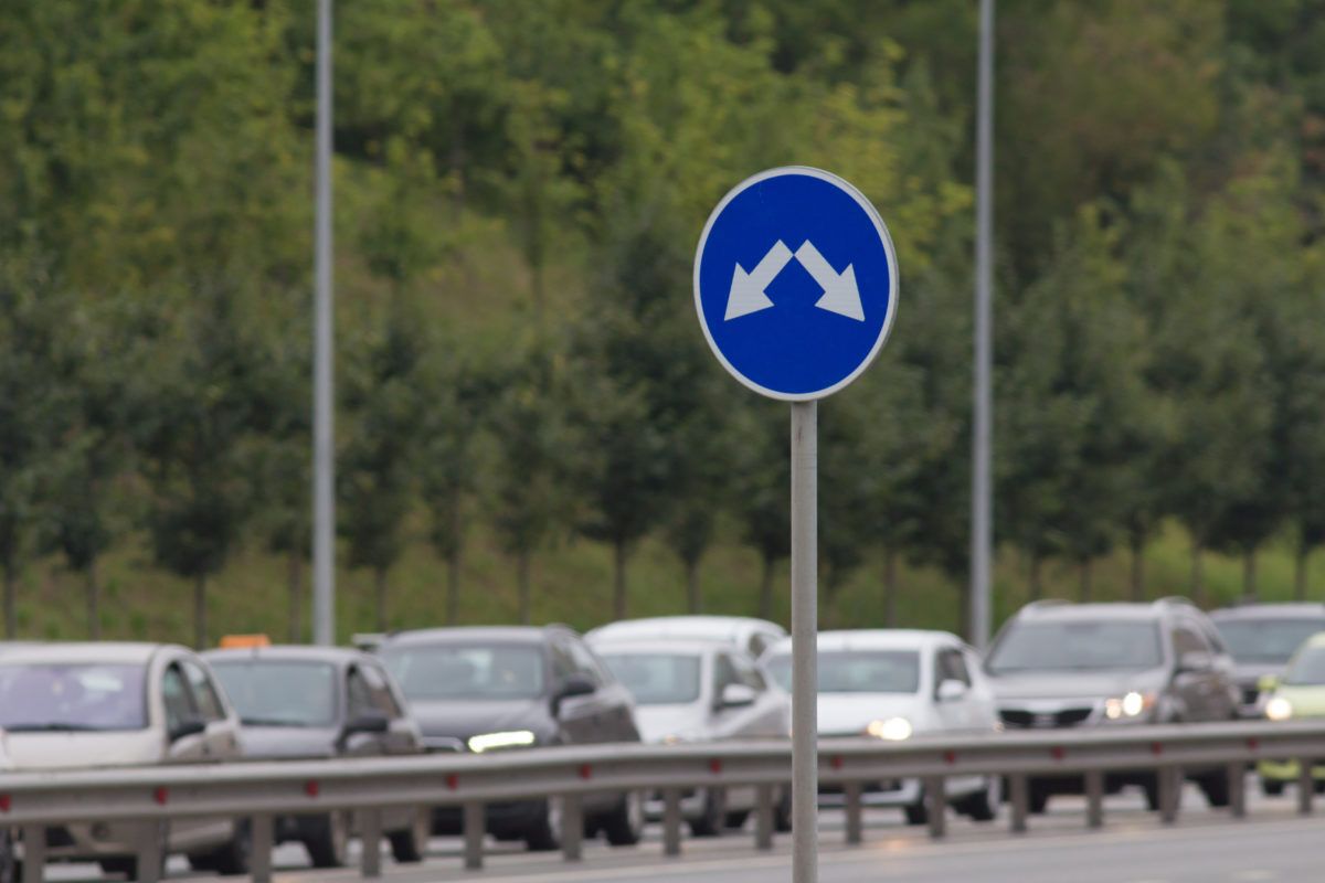 Cars sitting in traffic on a highway